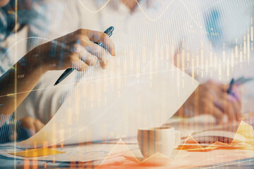 Double exposure of forex graph drawing over people taking notes background. Concept of financial analysis