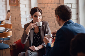 A manager having a meeting with his colleague at the coffee point.