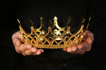 Woman holding beautiful golden crown, closeup. Fantasy item © New Africa