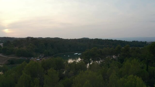 Aerial shot of a wake park in a lake in Carcassonne during a beautiful sunset