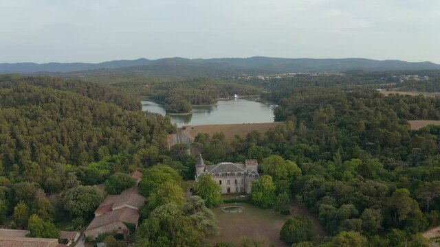 Aerial shot of a wake park in a lake in Carcassonne during a beautiful sunset