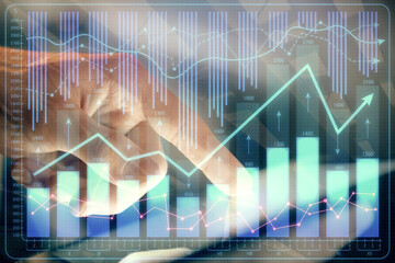 Multi exposure of man's hands holding and using a phone and financial chart drawing. Market analysis concept.