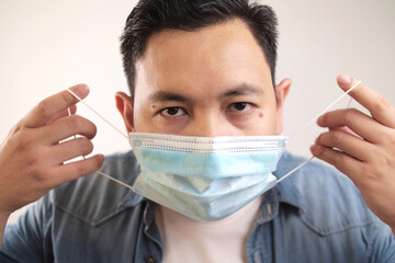 Asian man wearing medical mask coughing hard, covid-19 coronavirus patient, new normal
