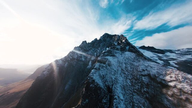 Aerial footage of mountain peaks covered in snow