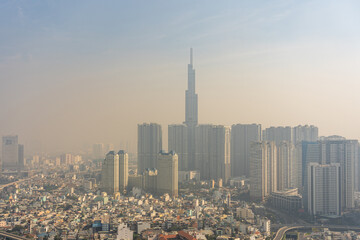 Air pollution of industrial city with hazy smog and skyscrapers