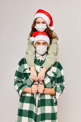 Fototapeta premium Man and woman hugs Christmas holiday fun medical masks