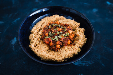 plant-based food, vegan chickpea tomato and mushroom stew with spicy couscous