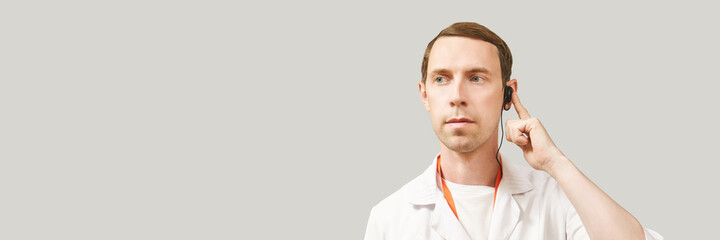Male doctor headphones. Studio Medicine portrait. Clinic online help. Health support call....