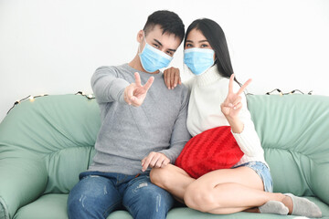 couple love wear mask sitting at the room 