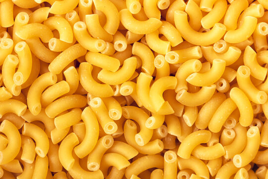 Dry macaroni pasta backround. Close up view.