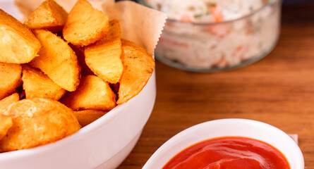 Tradition french fries from organic bio potato wedges with skin dip in ketchup