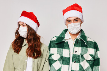 Man and woman in medical masks New Years holiday friendship together