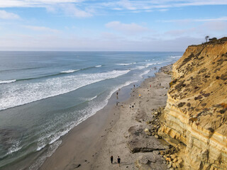 Dog Beach off-leash on Del Mar North Beach, people walking their dogs. San Diego County,...