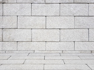 Grey brick wall with sidewalk. Empty background