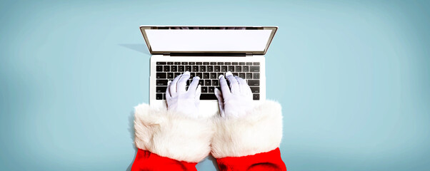 Santa Claus using a laptop computer from above