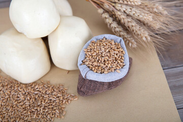 Steamed white noodle buns and raw wheat and wheat ears