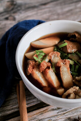 Chinese roll noodles soup with crispy pork and egg , noodle. Thai language called 
