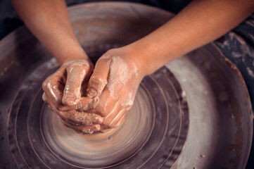 Artisan woman working with pottery at the ceramic workshop. Handicraft. Close-up.