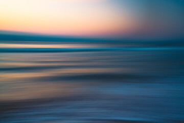 Naklejka na ściany i meble Before sunrise abstract seascape background in soft blur light pink, yellow, blue, and cyan colors