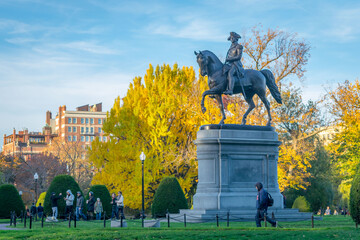 Visitors to the Boston Public Garden pass the George Washington Statue in fall