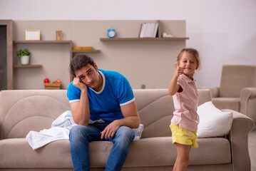 Young man with his daughter at home