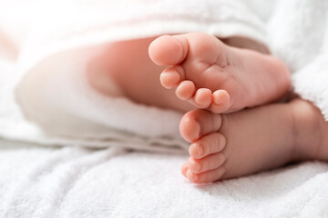 Closeup Shoot of a Four Week Old Baby Boy Feet Over Heap of White Towes.