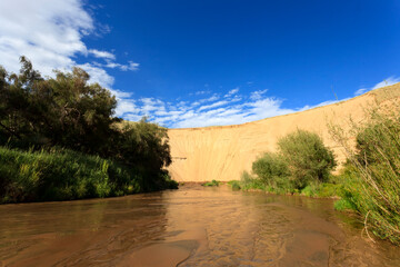 Mukhart River sources out of Great Mongol desert towers 450 m above the surrounding plain. 