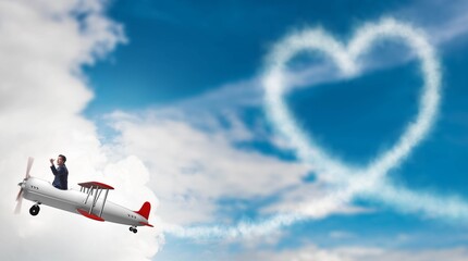 Naklejka na ściany i meble Man flying airplane and making heart shape