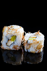 Japanese Cuisine Concepts. Pair of Traditional Sushi Rolls Placed Together on Black Reflective Surface.