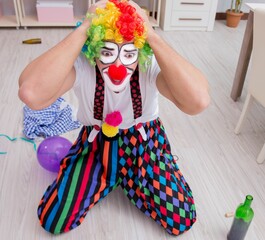 The drunk clown celebrating having a party at home