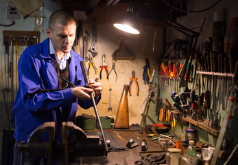 Fototapeta na wymiar Routine work of gunsmith in a weapons workshop