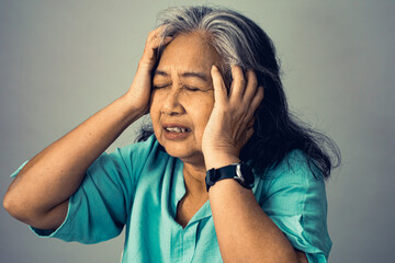 Close up on an Asian senior adult woman suffering from a mental disorder breakdown sickness, mental disorder concept, negative emotion, Alzheimer, depression and difficult life situation concept