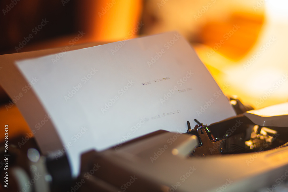 Fototapete process of writing a text letter on a white sheet of paper with old-fashioned typewriter, modern wri