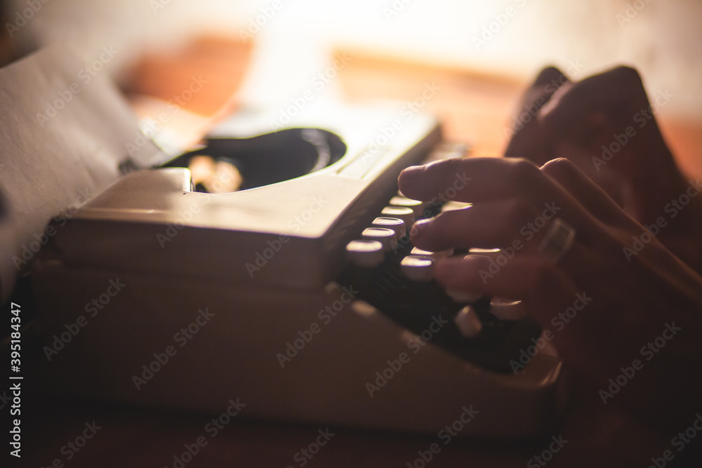 Fototapete process of writing a text letter on a white sheet of paper with old-fashioned typewriter, modern wri