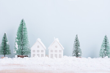 Christmas tree and home with snow frost field of natural Landscape background for celebration and Happy New Year