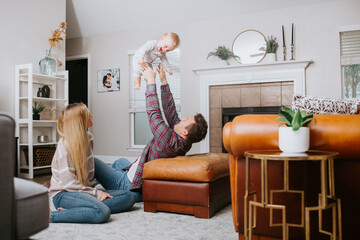 Young Couple at home Playing with Baby