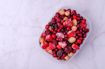 Frozen berry mix in a plastic container