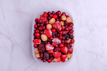 Frozen berry mix in a plastic container