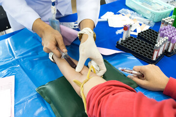 doctor injection needle on arm to collect blood for test the health selective focus syringe