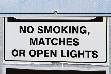 A No Smoking Matches or Open Lights sign