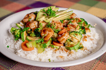 Fototapeta na wymiar Delicious shrimp teriyaki with broccoli, pumpkin, carrot and rice in oyster sauce on a white plate.