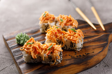 Appetizing rolls on a textured background. Japanese food concept. Close-up.