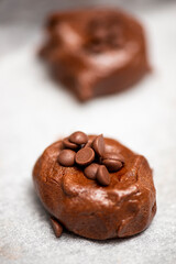 Classic chocolate chip cookies being prepared before baking, food background.