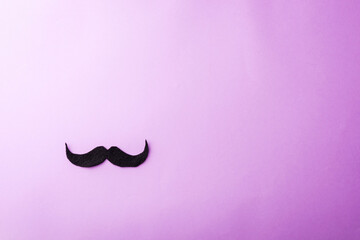 Black mustache paper, studio shot isolated on purple background, Prostate cancer awareness month, Fathers day, minimal November moustache concept