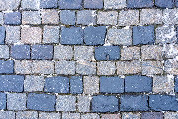 Paving stones on Red Square in Moscow from gabbro-diabases from the islands of Lake Onega in Karelia as a natural background
