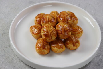 Pinneapple tart, Indonesian name it with Nastar Cookies. Has a small size, and filled with pinneapple jam.
