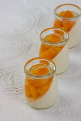 Puding buah mangga. Mango fruit pudding in a glass on a white background.