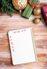 Holiday decorations and notebook with wish list on rustic table, flat lay style. Planning concept.