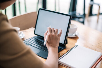 Close Up . Hands of woman designer using digital tablet to work at home or in the office.