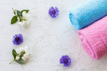 Obraz na płótnie Canvas Towels and beautiful flowers on a white background.